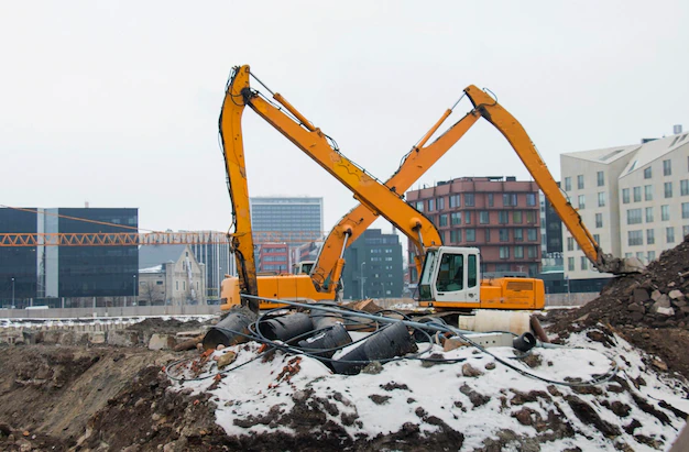 a-large-deep-foundation-pit-is-digging-excavators-building-a-house-in-the-city_350573-634